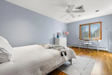 a bedroom with furniture and a lamp