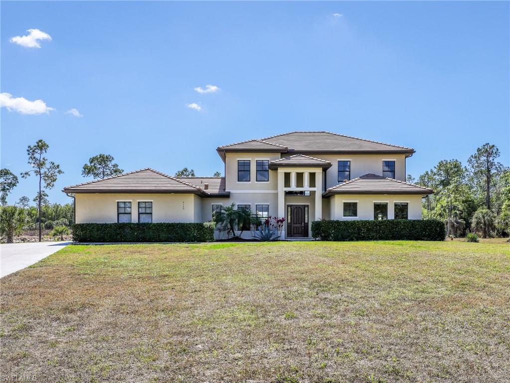 3160 27th Avenue Southwest Naples, FL 34117 - Photo 7 of 43 a front view of a house with a yard