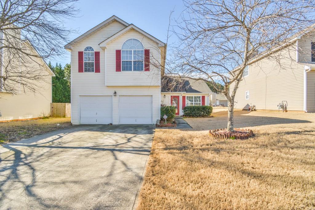 4769 Score Court Snellville, GA 30039 - Photo 1 of 1 a view of garage yard and tree