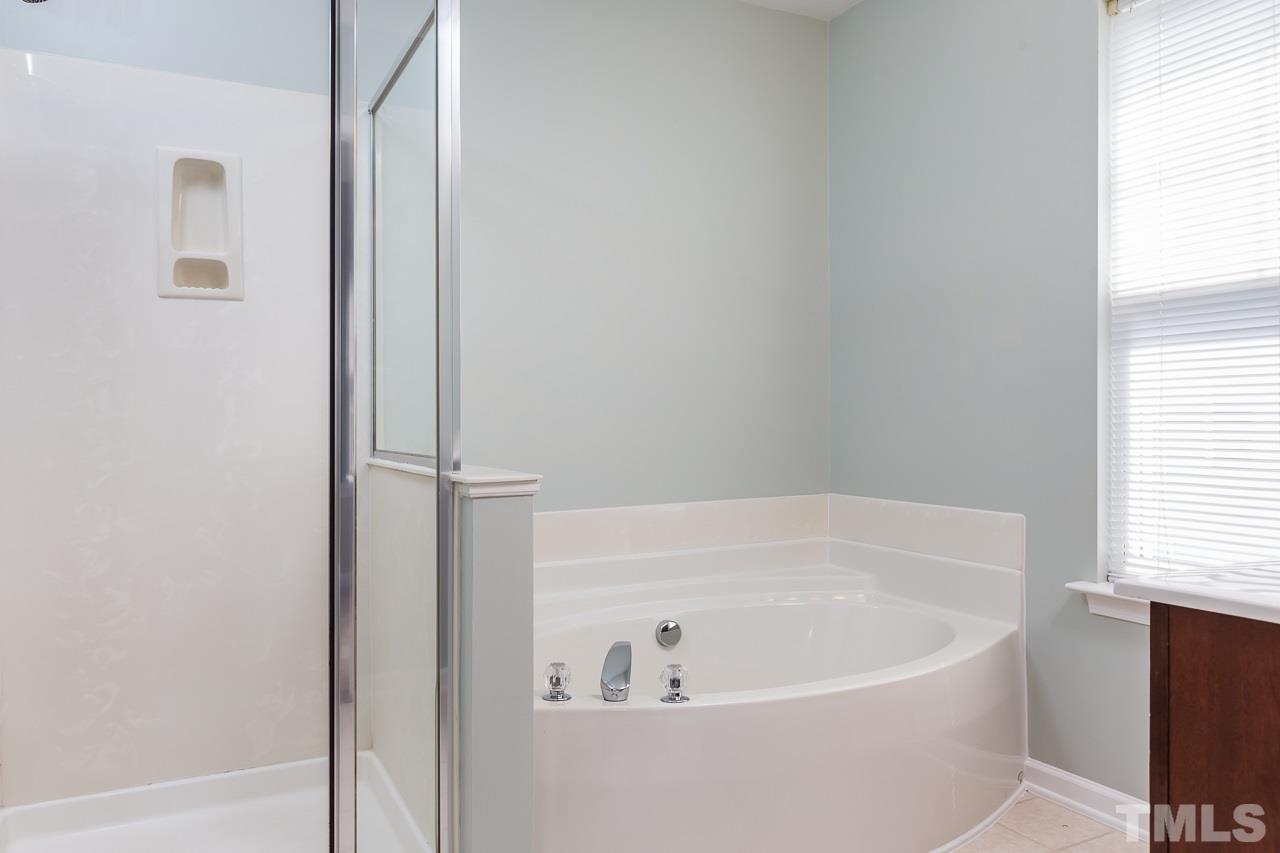 8485 Central Drive Raleigh, NC 27613 - Photo 14 of 25 a white bath tub sitting next to a window