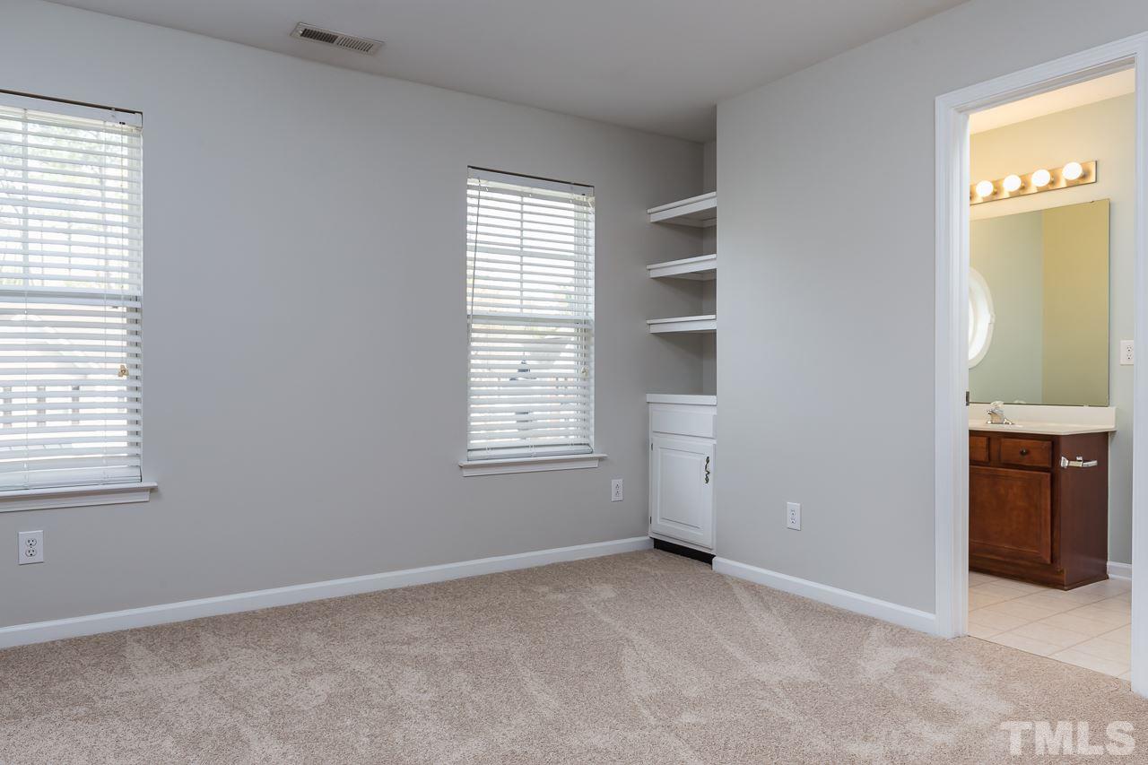 8485 Central Drive Raleigh, NC 27613 - Photo 16 of 25 an empty room with windows and cabinet