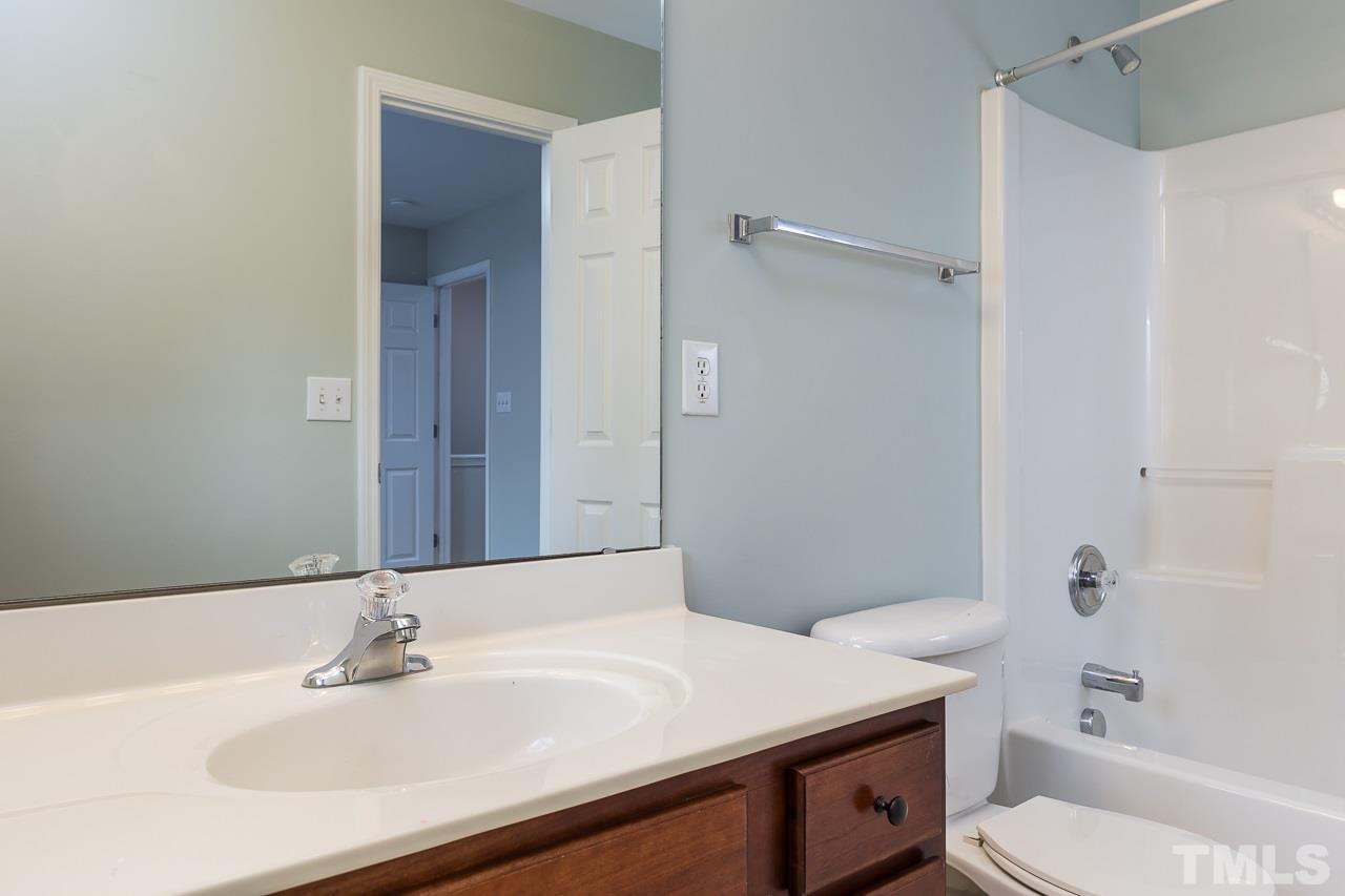 8485 Central Drive Raleigh, NC 27613 - Photo 18 of 25 a bathroom with a sink toilet vanity and shower