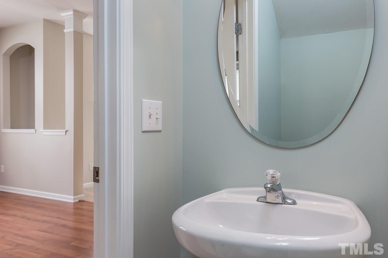 8485 Central Drive Raleigh, NC 27613 - Photo 20 of 25 a bathroom with a sink and a mirror
