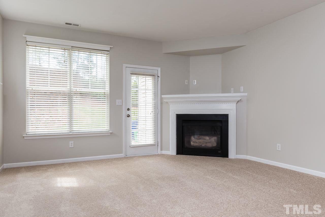 8485 Central Drive Raleigh, NC 27613 - Photo 4 of 25 a view of an empty room with a window and fireplace