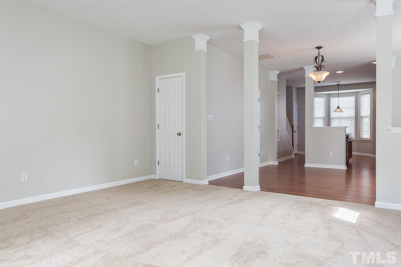 8485 Central Drive Raleigh, NC 27613 - Photo 5 of 25 a view of a hallway with wooden floor and cabinet