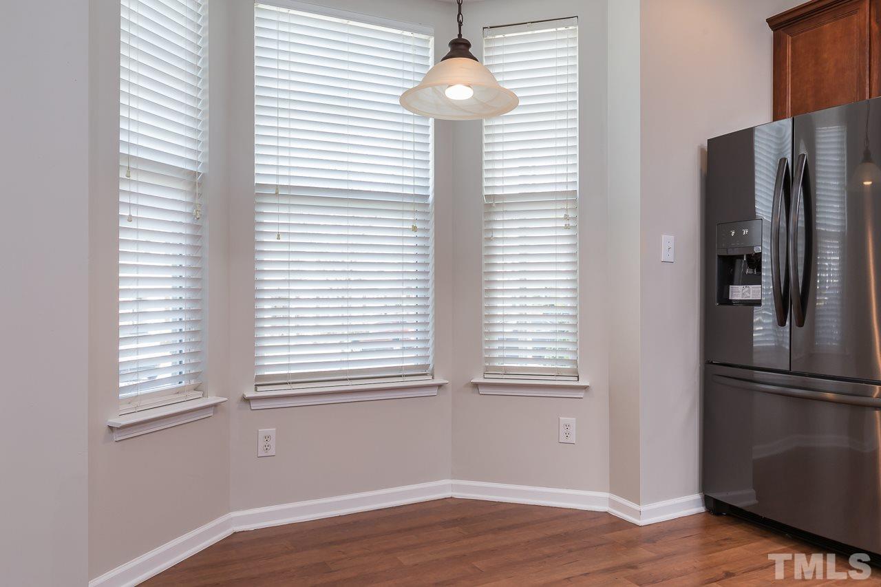 8485 Central Drive Raleigh, NC 27613 - Photo 9 of 25 a view of an empty room with wooden floor and a window