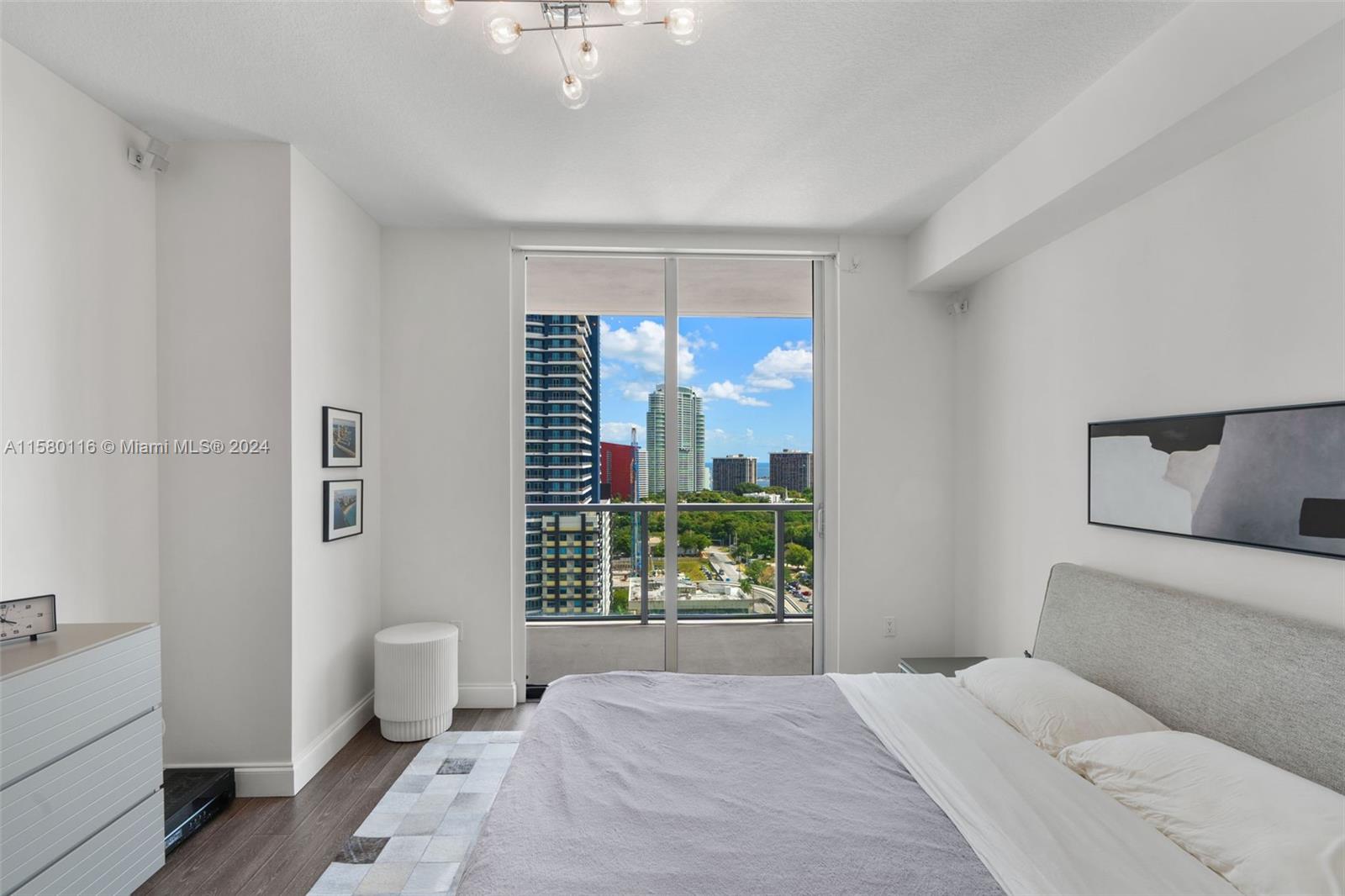79 Southwest 12th Street, Unit 2204S Miami, FL 33130 - Photo 12 of 40 a bedroom with a large bed and a window