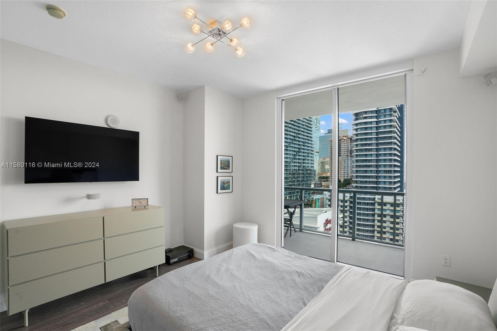 79 Southwest 12th Street, Unit 2204S Miami, FL 33130 - Photo 14 of 40 a living room with furniture and a flat screen tv