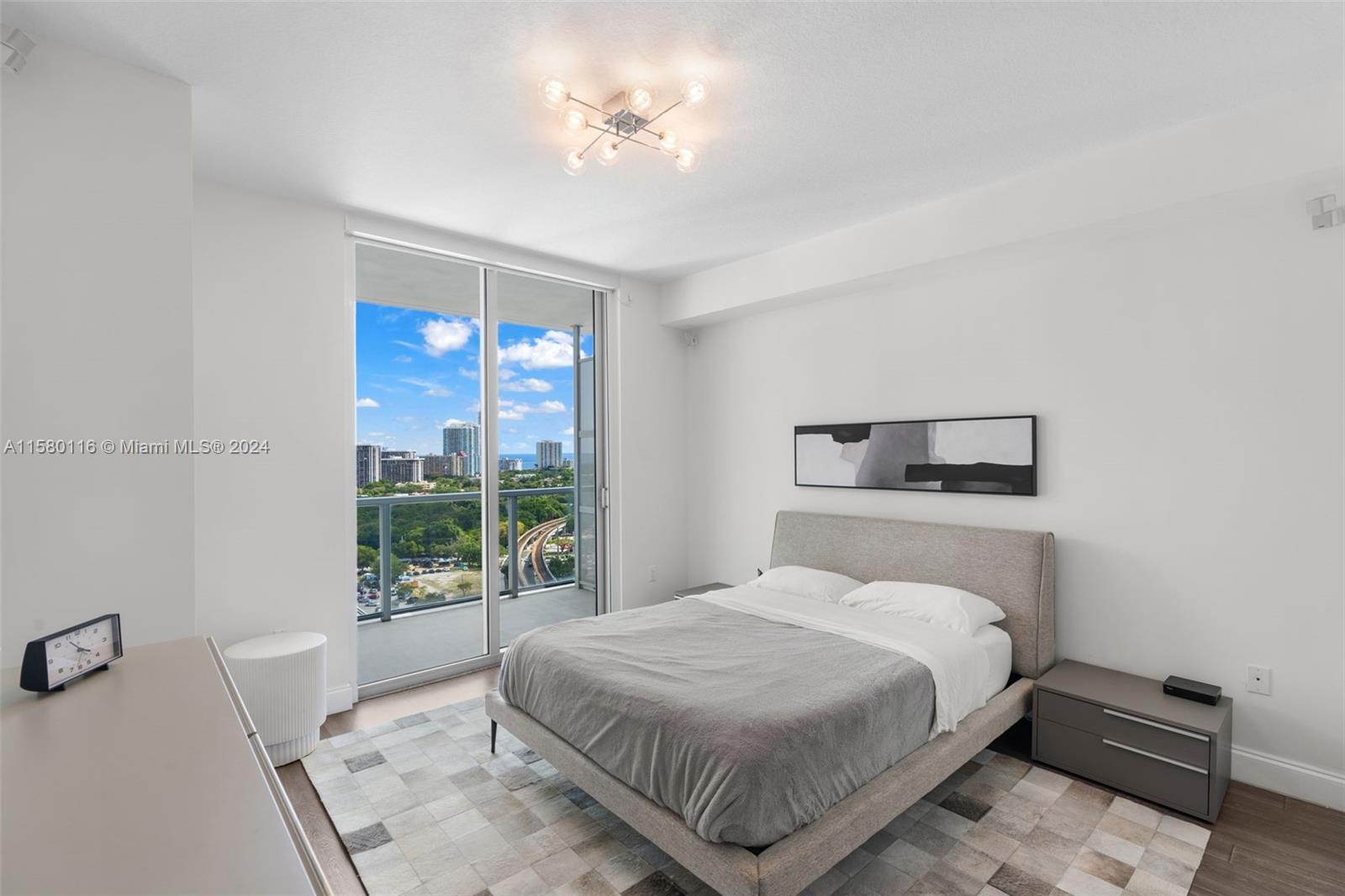 79 Southwest 12th Street, Unit 2204S Miami, FL 33130 - Photo 15 of 40 a bedroom with a bed and a window