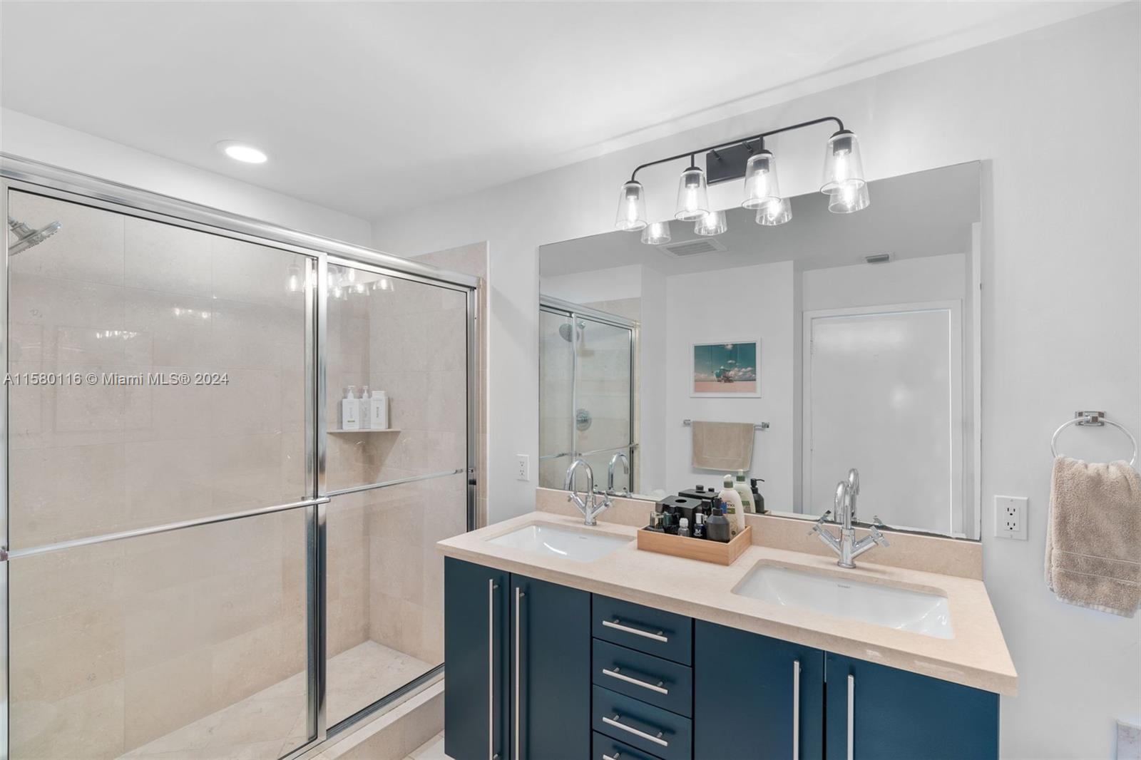 79 Southwest 12th Street, Unit 2204S Miami, FL 33130 - Photo 17 of 40 a bathroom with a sink double vanity and a mirror