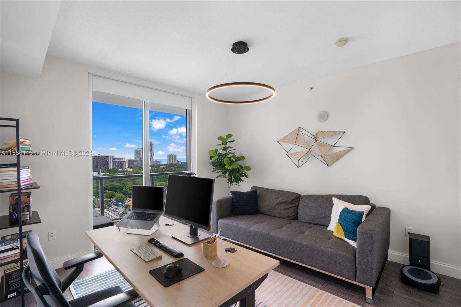 79 Southwest 12th Street, Unit 2204S Miami, FL 33130 - Photo 19 of 40 a living room with furniture and a laptop
