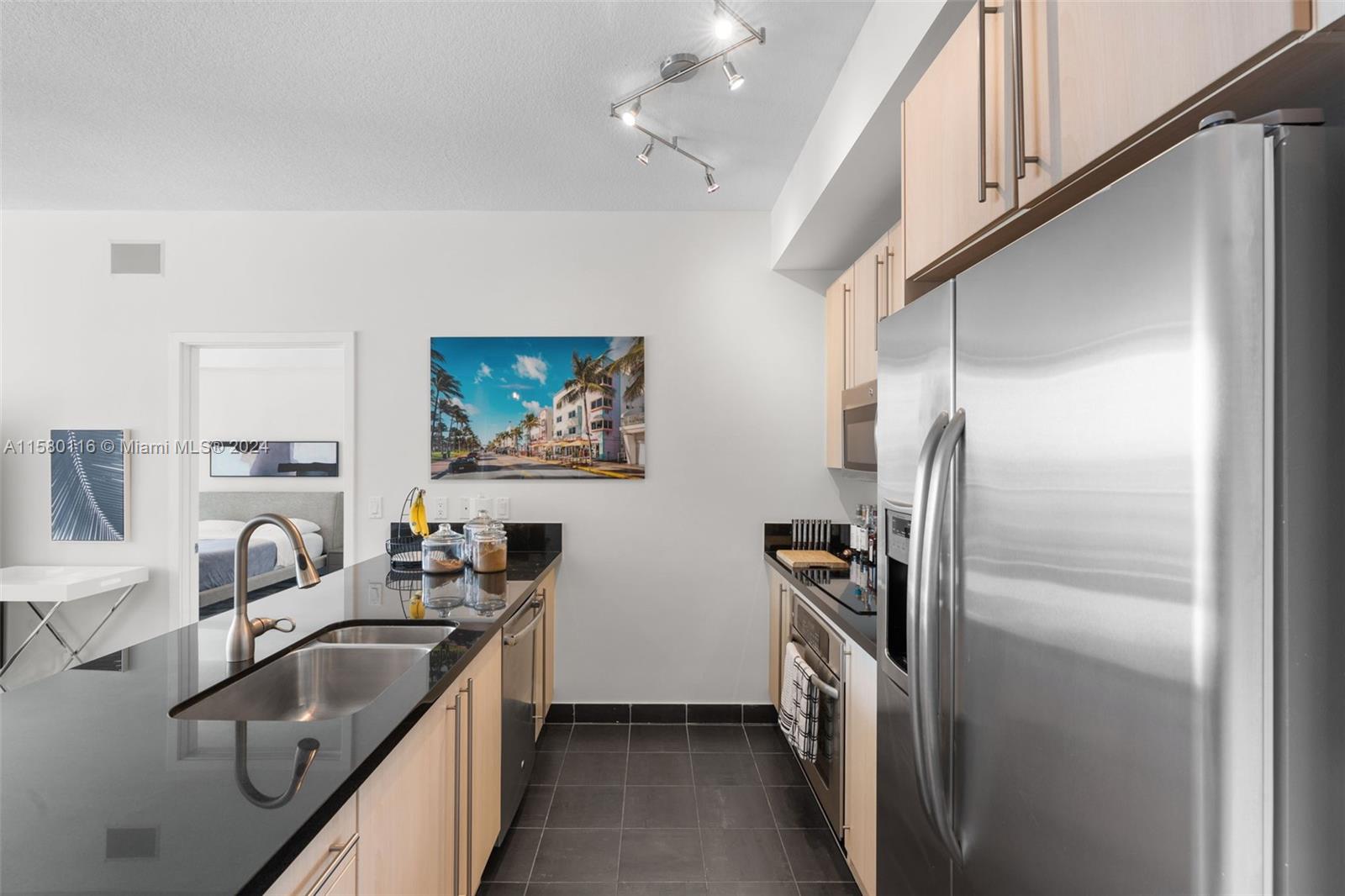 79 Southwest 12th Street, Unit 2204S Miami, FL 33130 - Photo 2 of 40 a kitchen with refrigerator cabinets and a sink