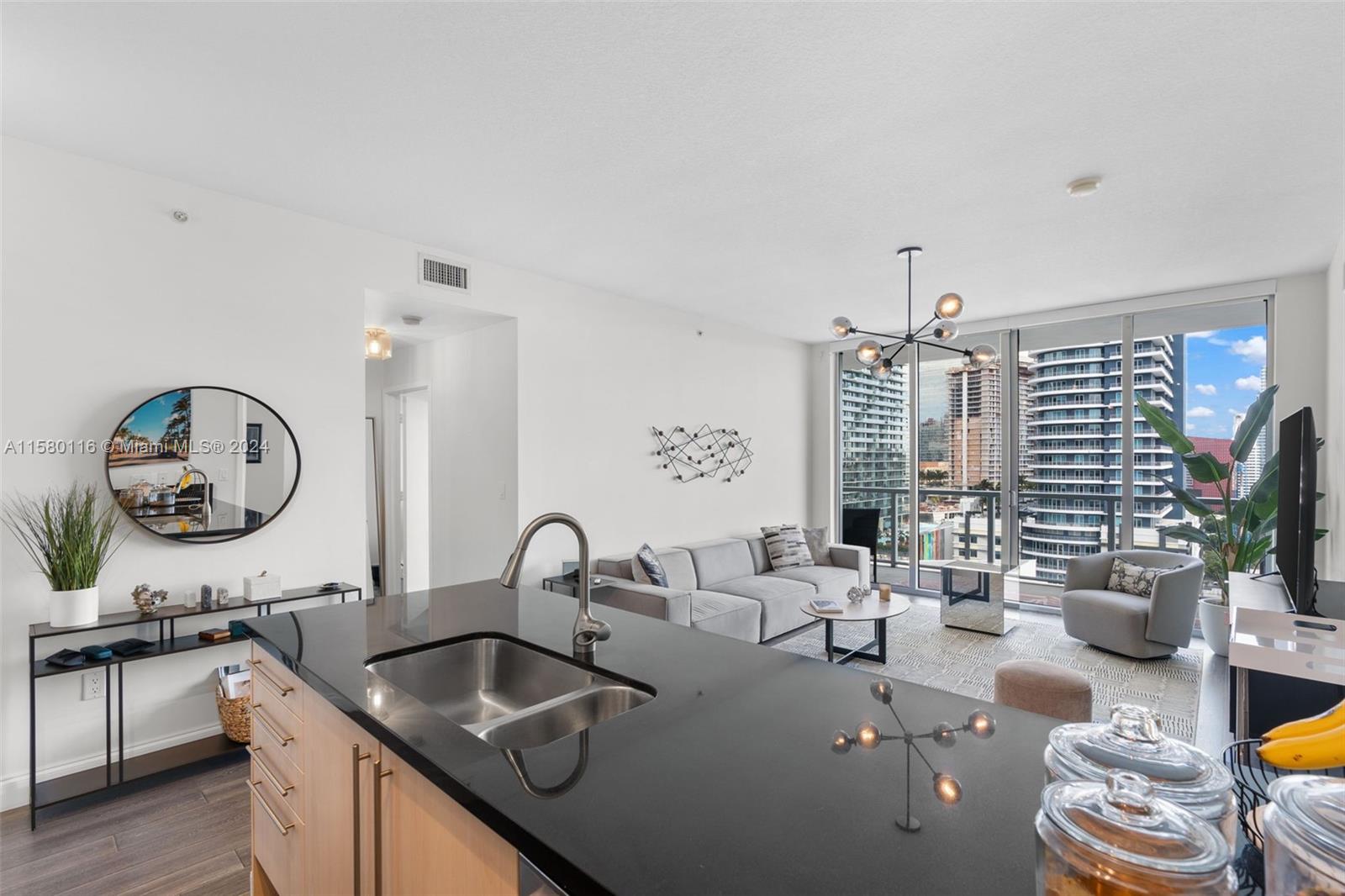 79 Southwest 12th Street, Unit 2204S Miami, FL 33130 - Photo 3 of 40 a very nice looking room with a large window and kitchen