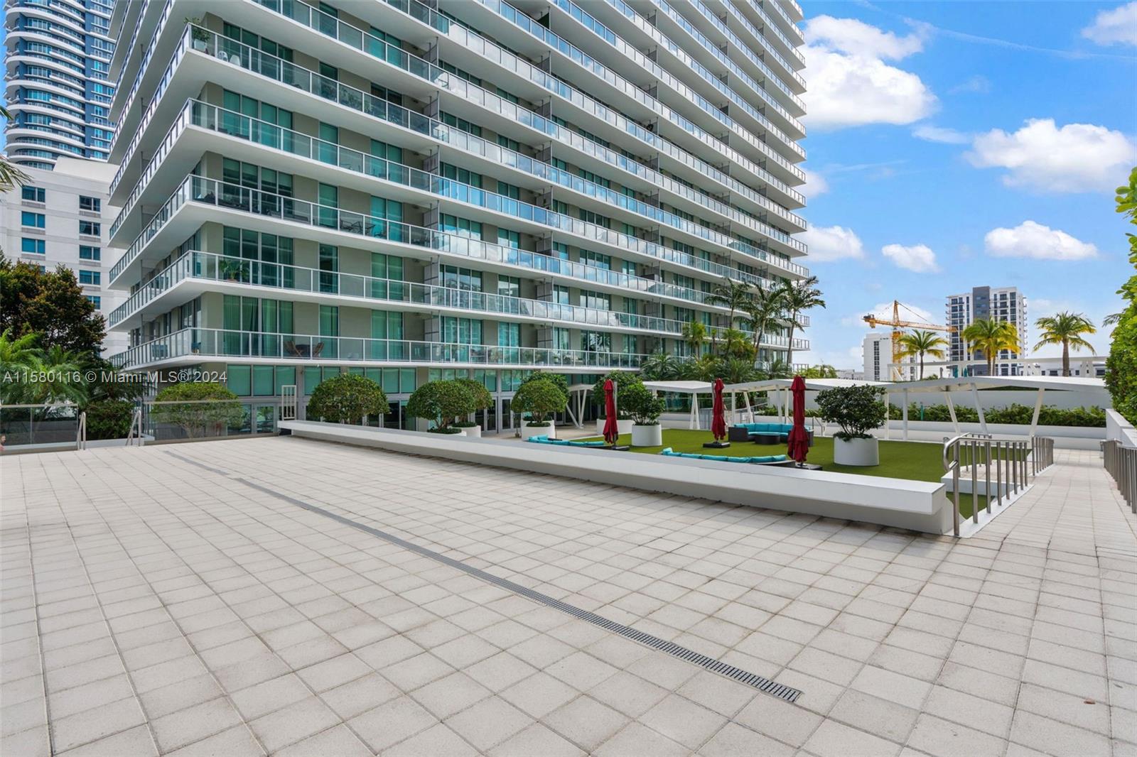 79 Southwest 12th Street, Unit 2204S Miami, FL 33130 - Photo 35 of 40 a view of pool with outdoor seating and plants