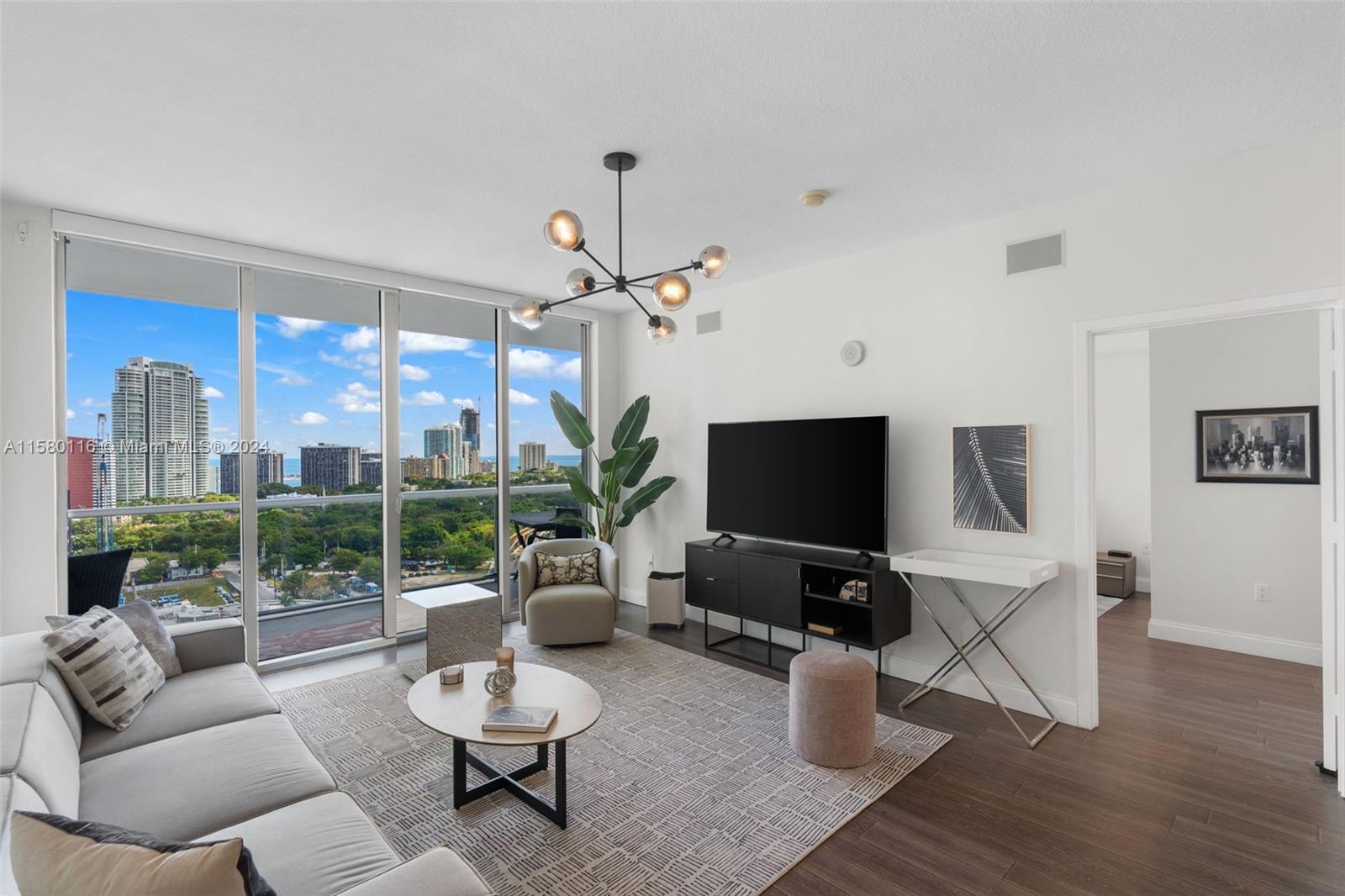 79 Southwest 12th Street, Unit 2204S Miami, FL 33130 - Photo 6 of 40 a living room with furniture and a flat screen tv