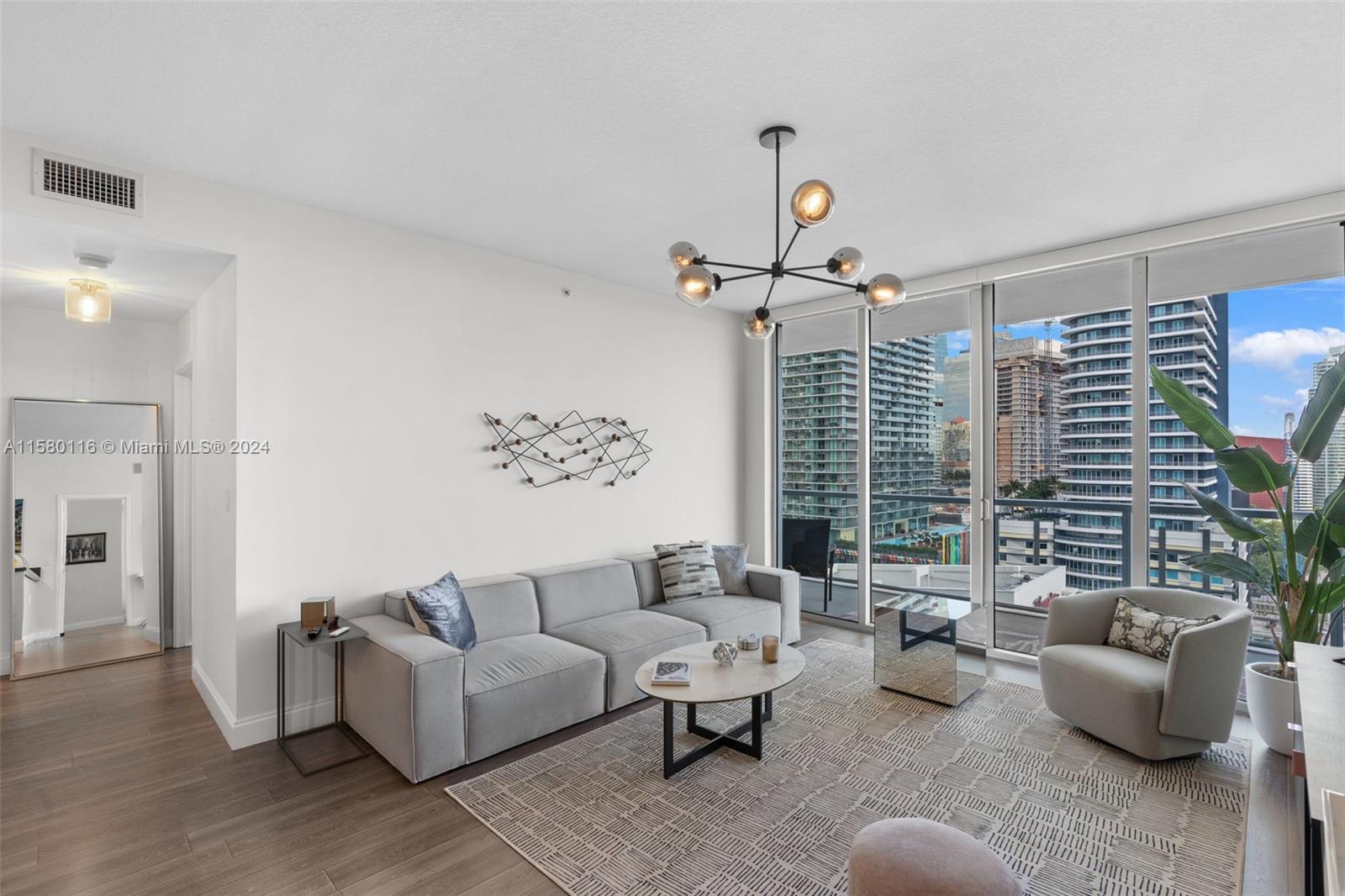 79 Southwest 12th Street, Unit 2204S Miami, FL 33130 - Photo 8 of 40 a living room with furniture and a large window