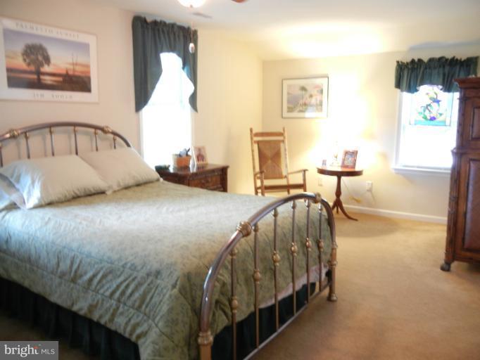 4040 Cliffvale Road Baltimore, MD 21236 - Photo 11 of 25 a bedroom with a bed and a table in it