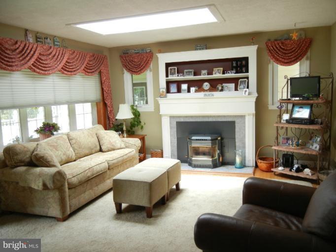 4040 Cliffvale Road Baltimore, MD 21236 - Photo 18 of 25 a living room with furniture and a fireplace