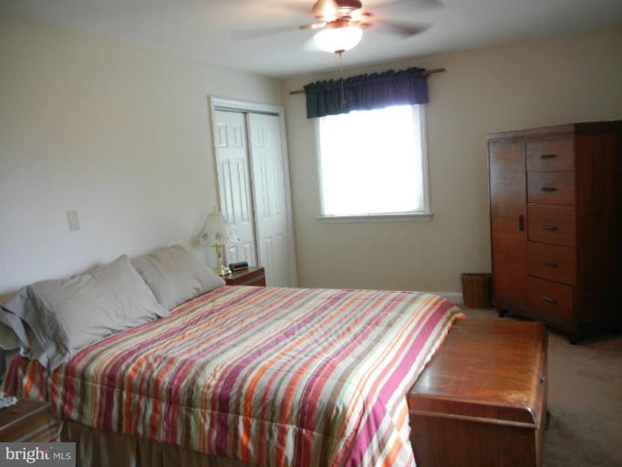 4040 Cliffvale Road Baltimore, MD 21236 - Photo 21 of 25 a bedroom with a bed and a chandelier