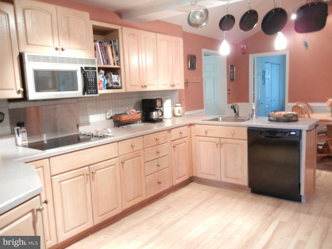 4040 Cliffvale Road Baltimore, MD 21236 - Photo 25 of 25 a kitchen with a sink dishwasher and a stove with wooden floor