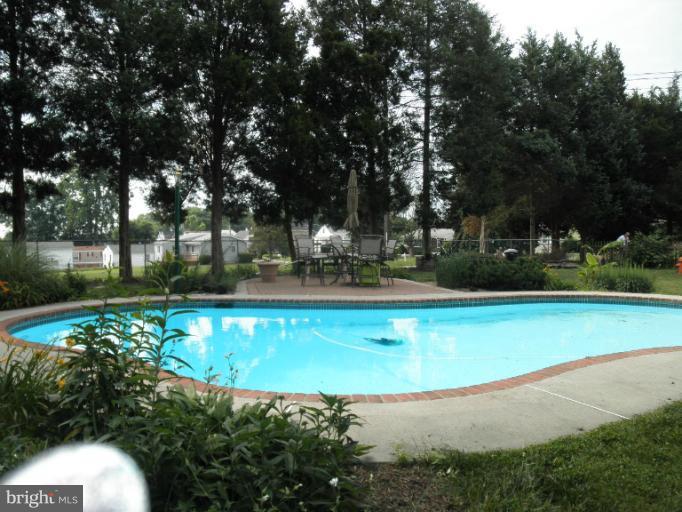 4040 Cliffvale Road Baltimore, MD 21236 - Photo 4 of 25 a view of a swimming pool with a yard