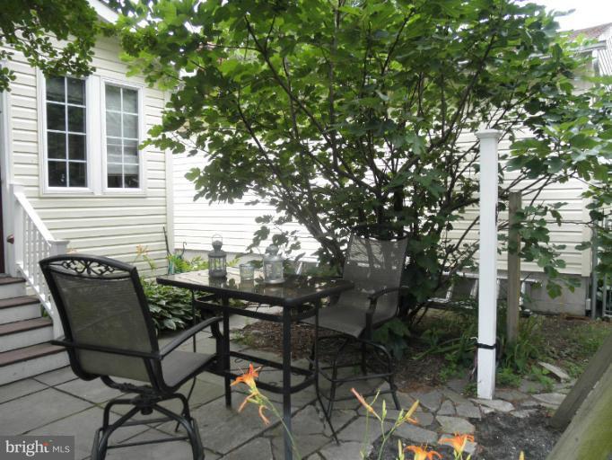 4040 Cliffvale Road Baltimore, MD 21236 - Photo 5 of 25 a view of a chairs and table in a backyard