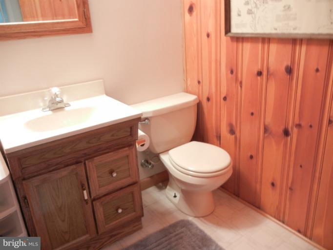 4040 Cliffvale Road Baltimore, MD 21236 - Photo 10 of 25 a bathroom with a sink a toilet and shower curtain