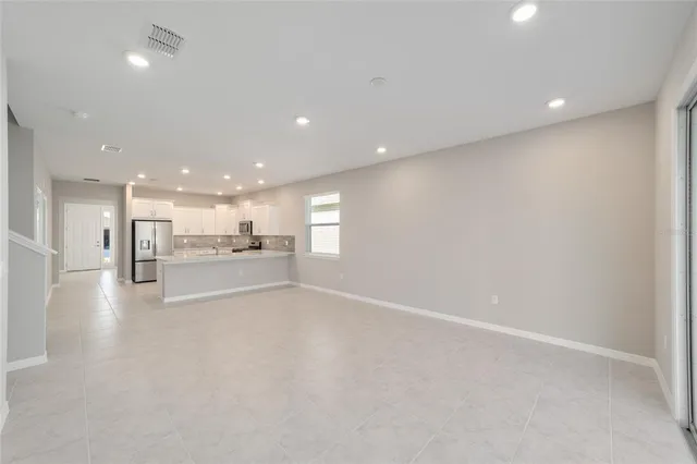 a view of a kitchen with a sink and dishwasher a refrigerator with wooden floor
