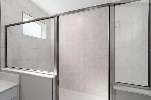 a bathroom with a glass shower door