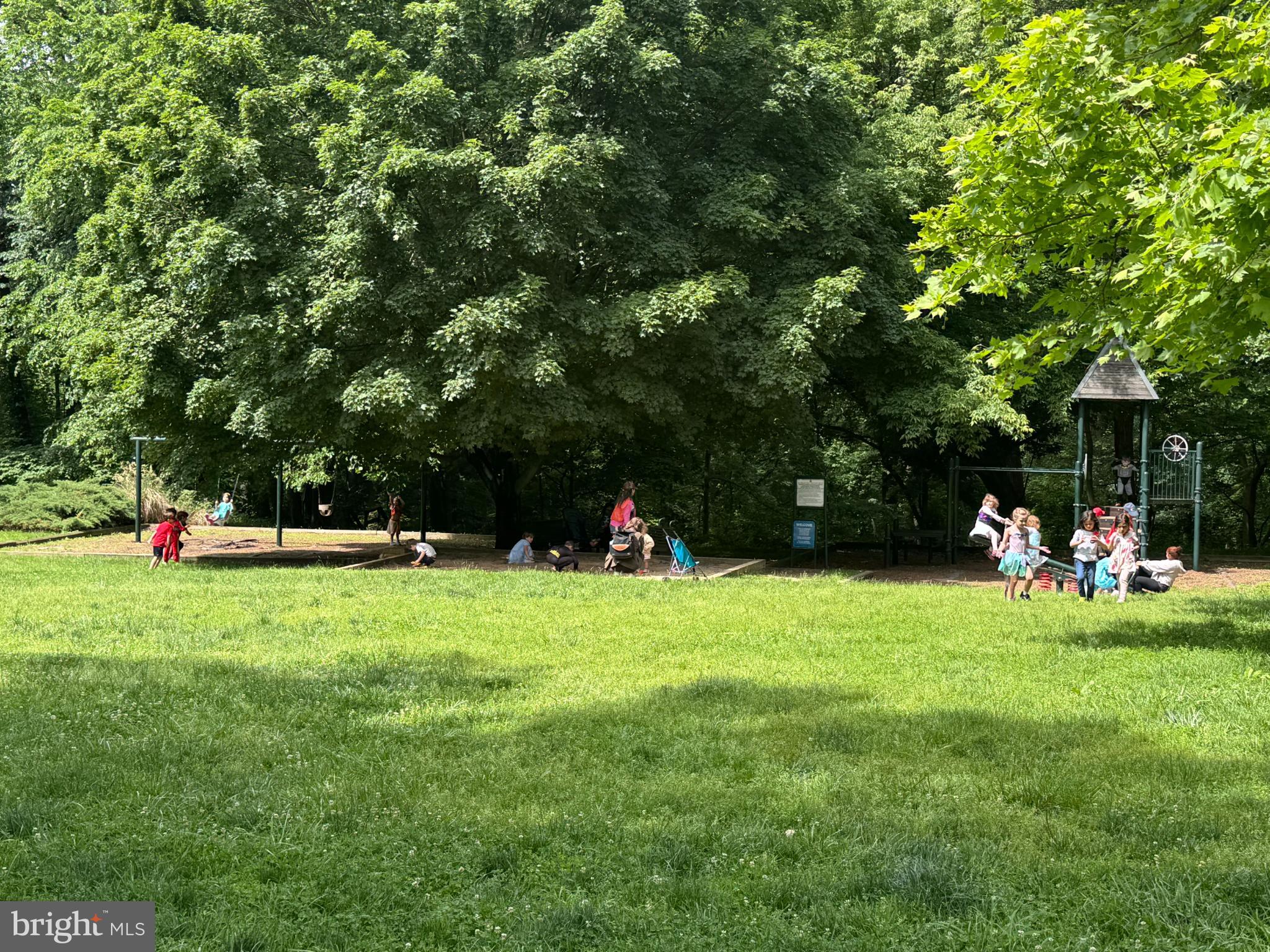 3811 39th Street Northwest, Unit D88 Washington, DC 20016 - Photo 19 of 20 Children playing joyfully in a lush park.