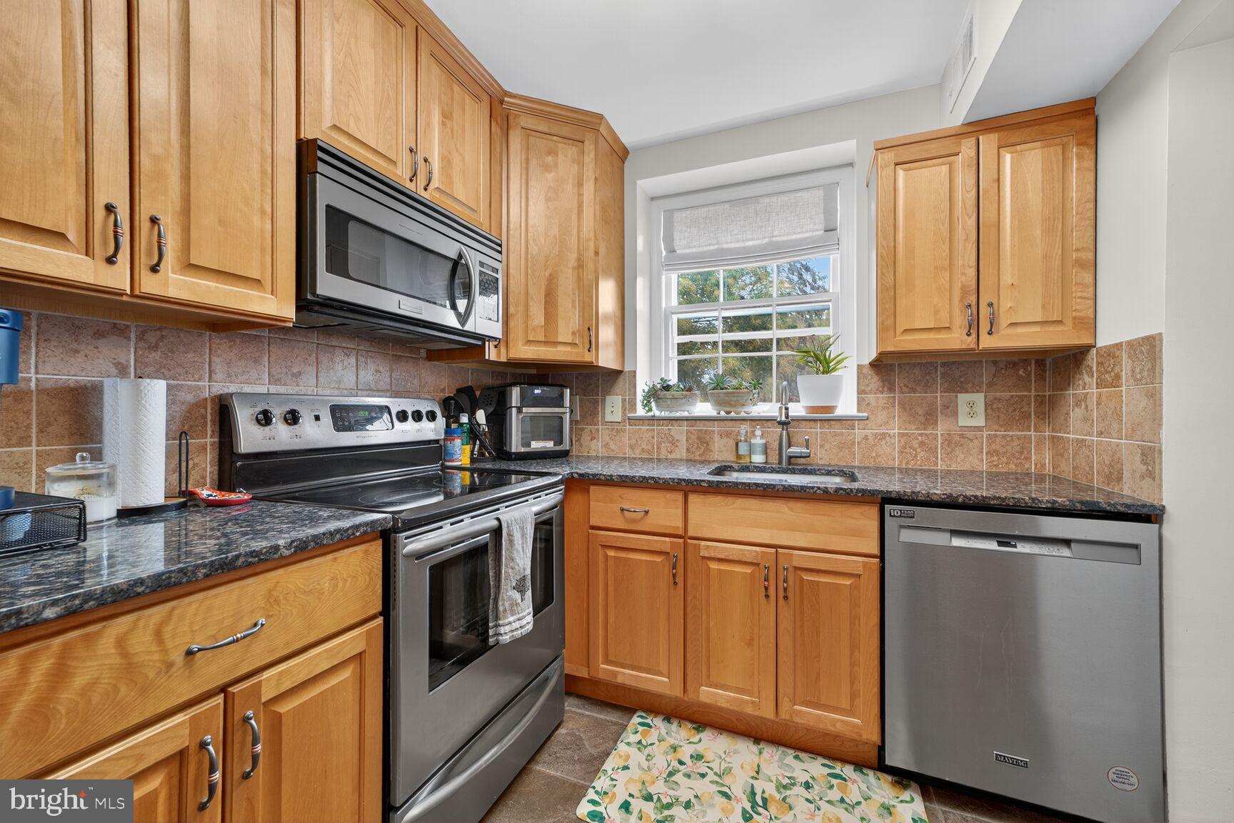 3811 39th Street Northwest, Unit D88 Washington, DC 20016 - Photo 7 of 20 Modern kitchen with warm wood accents.