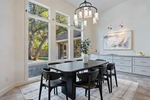 a view of a dining room with furniture a chandelier and wooden floor
