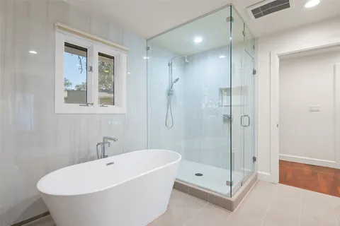 a white bath tub sitting next to a bathroom