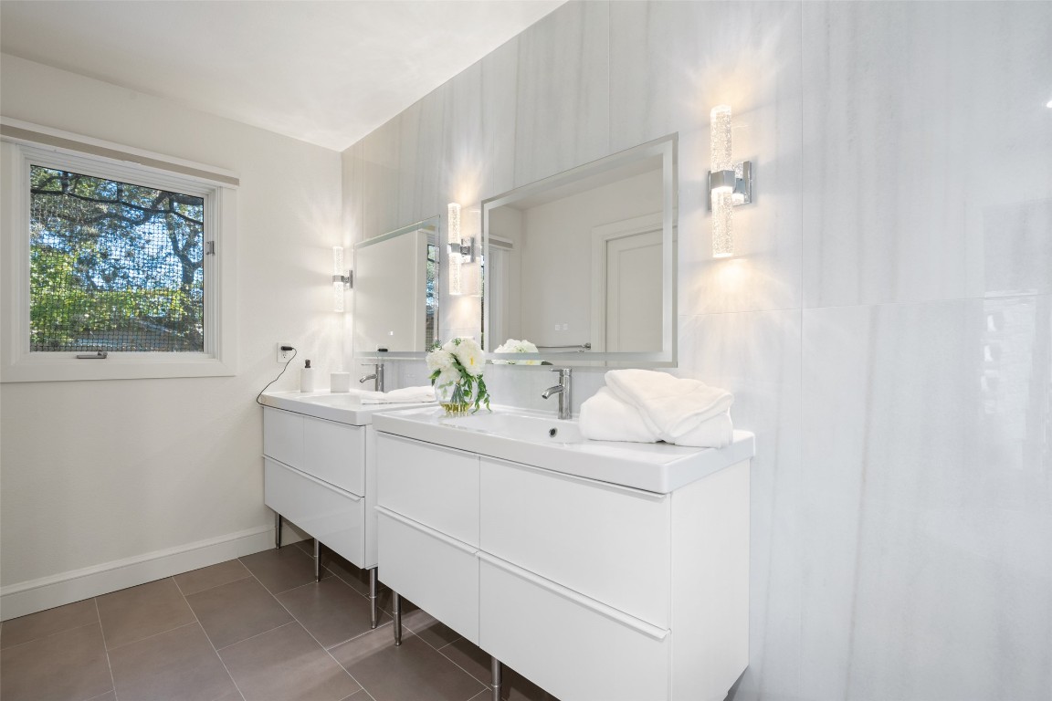 7603 Rustling Cove Austin, TX 78731 - Photo 17 of 34 a bathroom with a sink and a mirror