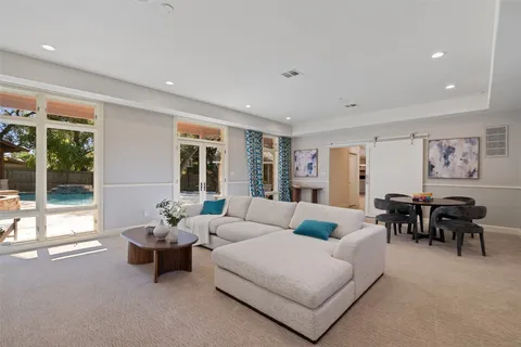 a living room with furniture and large windows