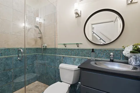 a bathroom with a sink a toilet and a mirror