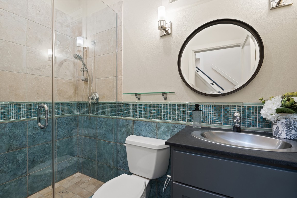 7603 Rustling Cove Austin, TX 78731 - Photo 21 of 34 a bathroom with a sink a toilet and a mirror