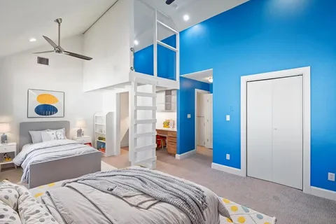 a bedroom with a bed and a chandelier