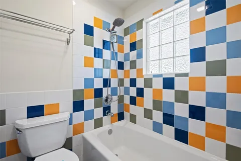 a bathroom with a toilet a shower and a sink