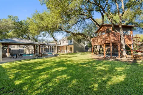 a view of a house with pool and sitting area