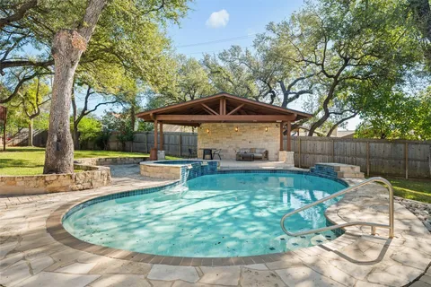 a view of a swimming pool with a patio
