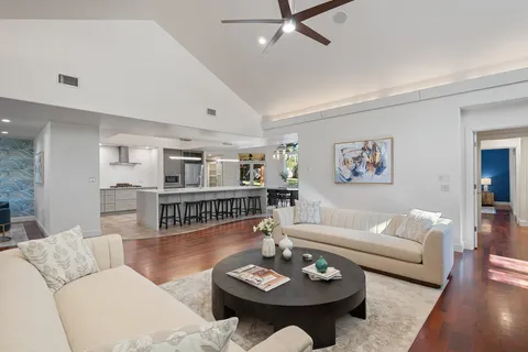 a living room with furniture and wooden floor
