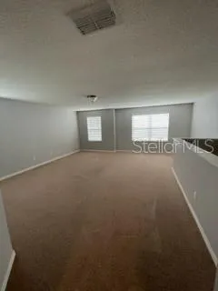 a view of an empty room and a window