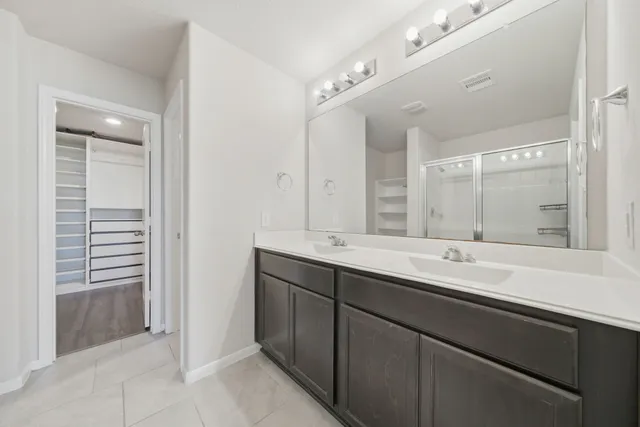 a bathroom with a double vanity sink mirror and double