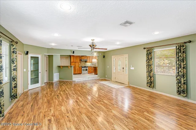 a kitchen with kitchen island granite countertop a sink stove and cabinets