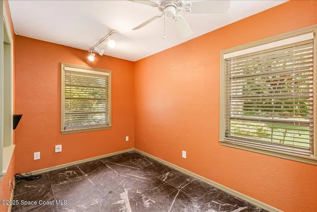 an aerial view of a house with pool outdoor space and trees all around