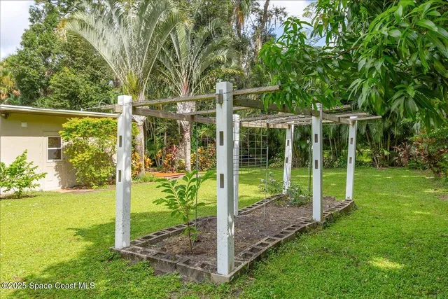 a view of a livingroom with wooden floor and a bathroom