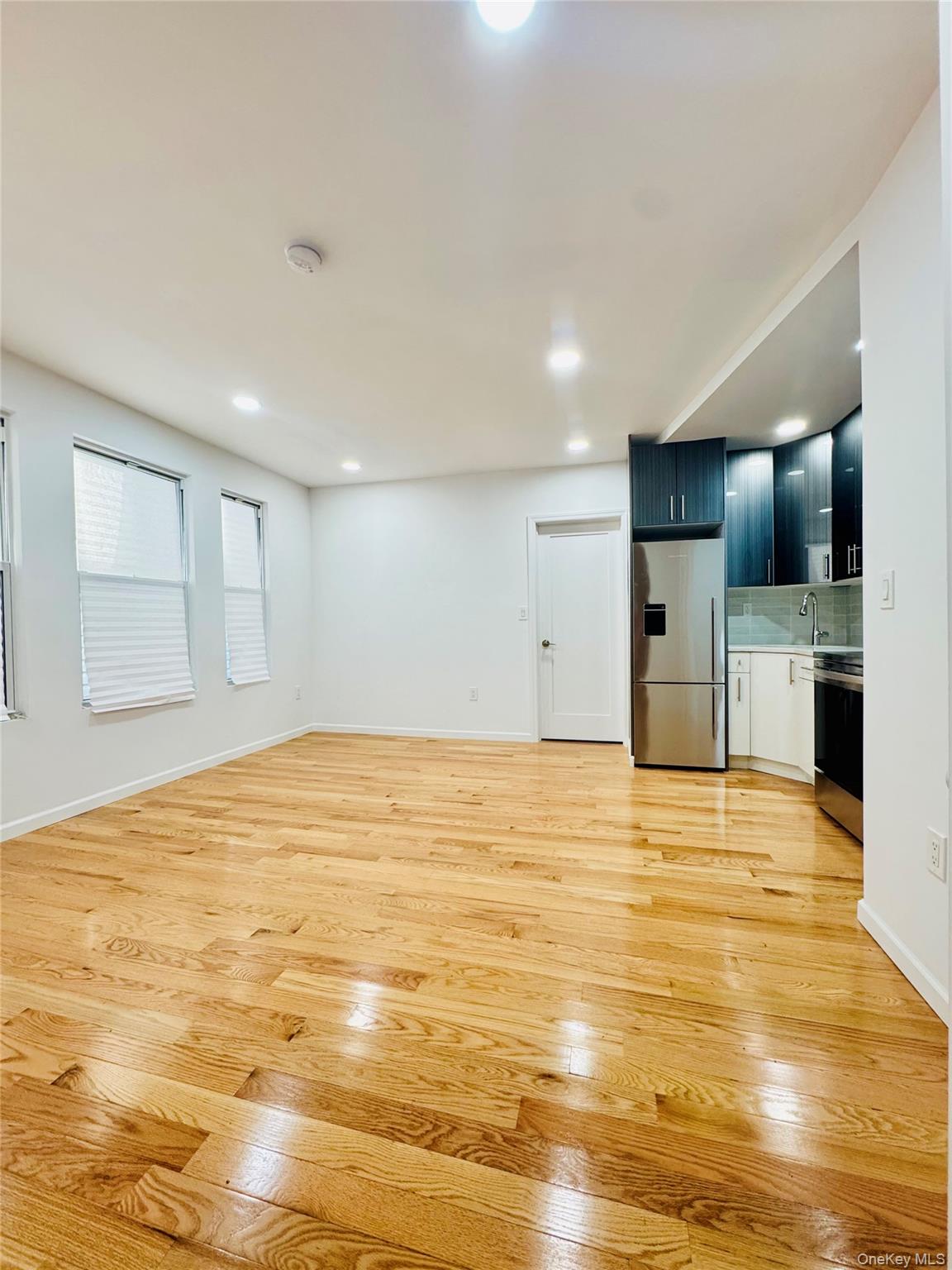 87-44 89th Street Queens, NY 11421 - Photo 3 of 10 a view of an empty room