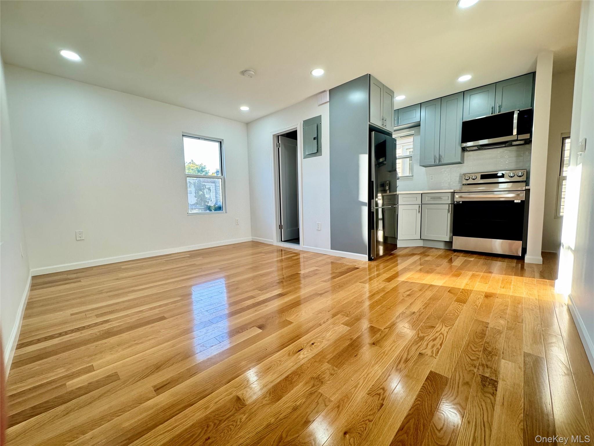 87-44 89th Street Queens, NY 11421 - Photo 6 of 10 a view of kitchen appliances and wooden floor