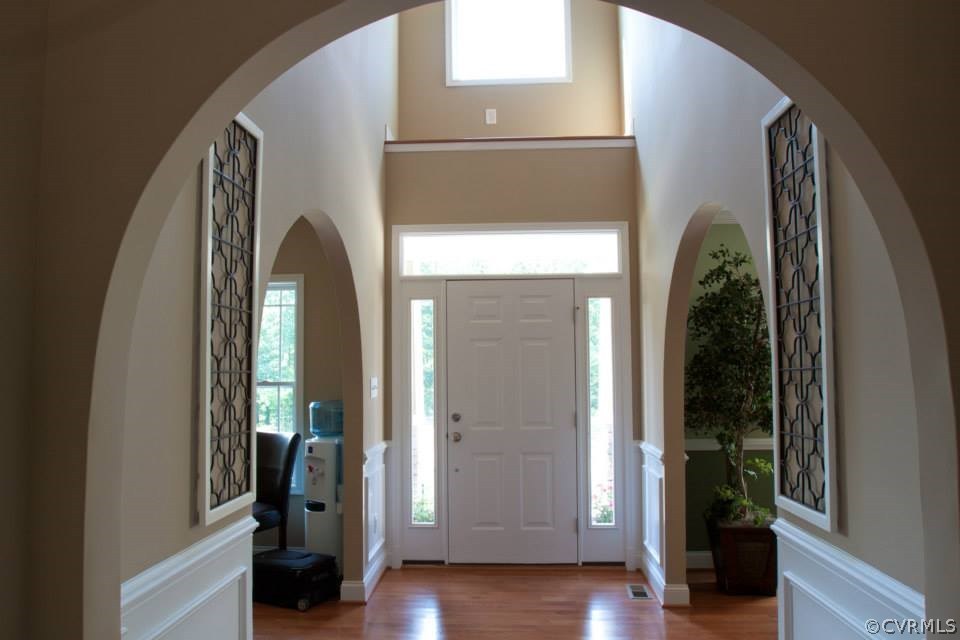 11024 Avening Road Midlothian, VA 23112 - Photo 6 of 16 a view of front door with hallway and wooden floor